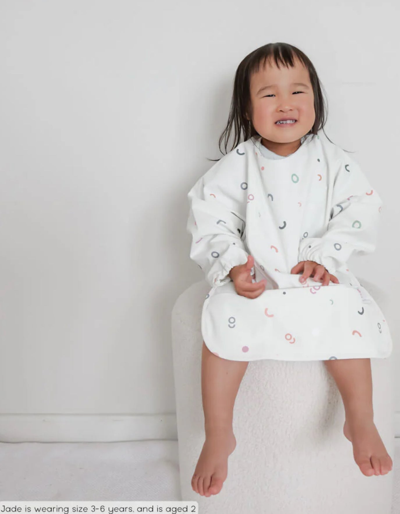We Might Be Tiny Smock Bib. Tiny Arches